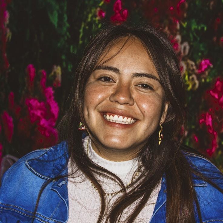 Avery Singh, Lead Design Curator at Quiet Valley Connection, reviewing corporate floral arrangements